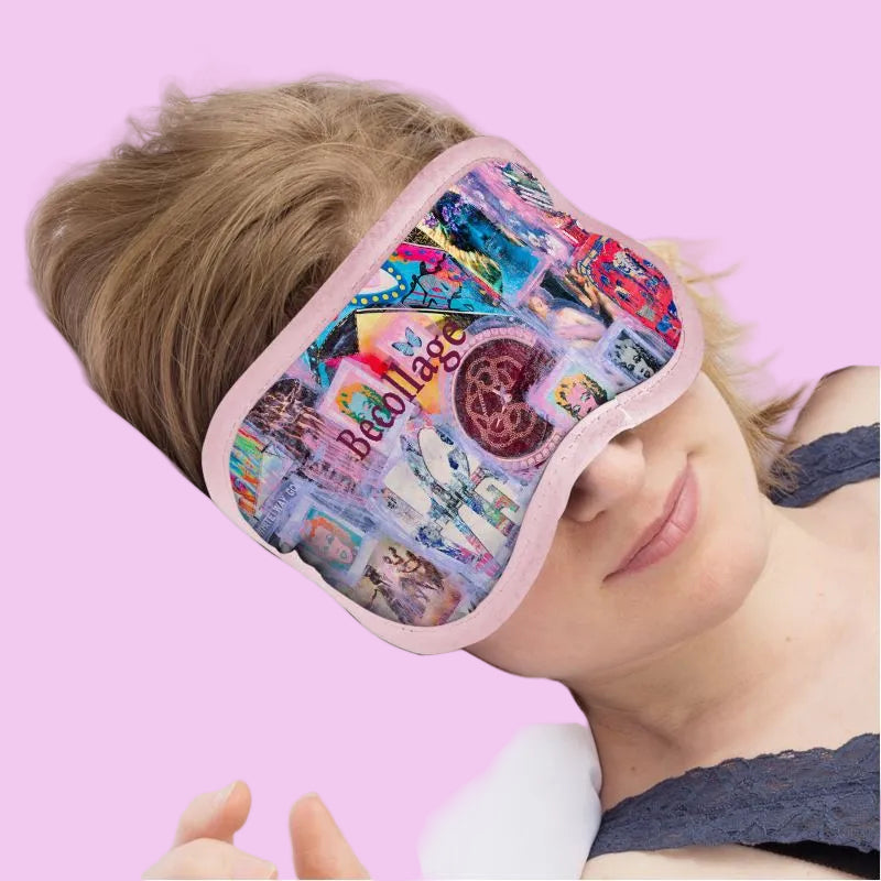 Person wearing a colorful sleep mask with a pink border on a pink background