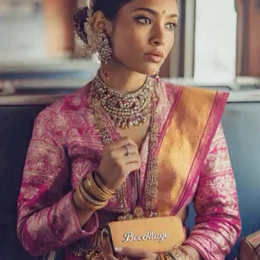 Woman in traditional pink and gold outfit with jewelry, holding a 'Becollage' box.